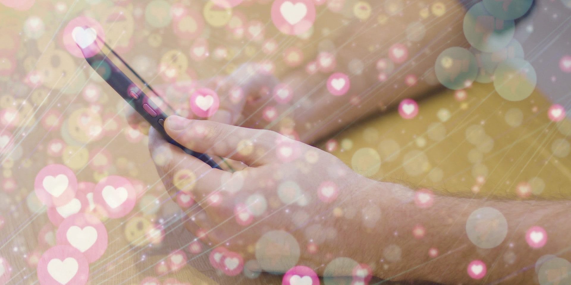 Hände halten ein Smartphone, während viele grafische pastellige Herzsymbole und Bubbles darüber eingeblendet sind.