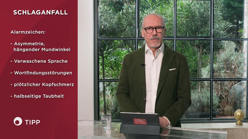 Im Studio gibt Prof. Dr. Siegfried Meryn Informationen zu den Alarmzeichen eines Schlaganfalls, die in einer Informationsgrafik links im Bild angeführt werden.